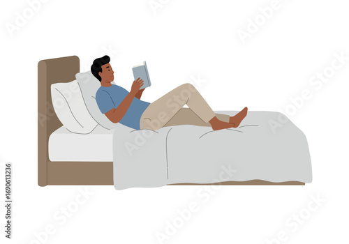 Man Relaxing in Bed Reading a Book, Enjoying Leisure Time