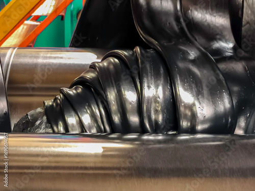 Rubber, oil and chemicals are mixed homogeneously on the rubber mixer. Rubber producing.