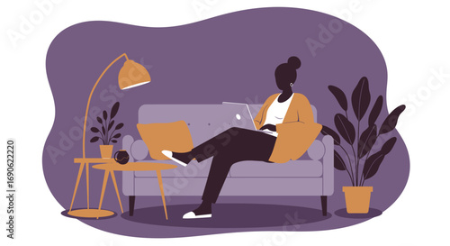 African American woman working remotely on laptop at home. She sits comfortably on a sofa in a modern, plant-filled living space, symbolizing flexible work.