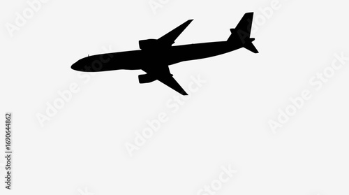 Silhouette of a large passenger jet in flight against a plain background.