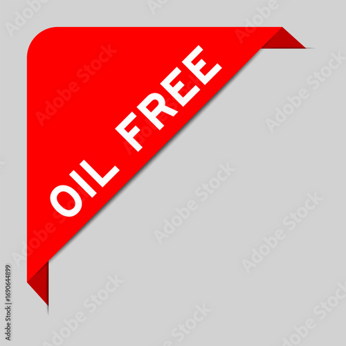 Red color of corner label banner with word oil free on gray background