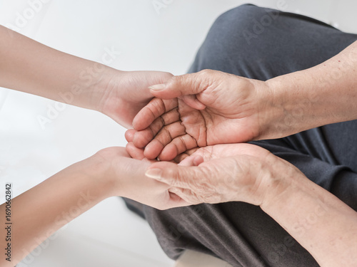 Parkinson disease patient, Alzheimer elderly senior, Arthritis person's hand in support of nursing family caregiver care for disability awareness day, National care givers month, aging society concept