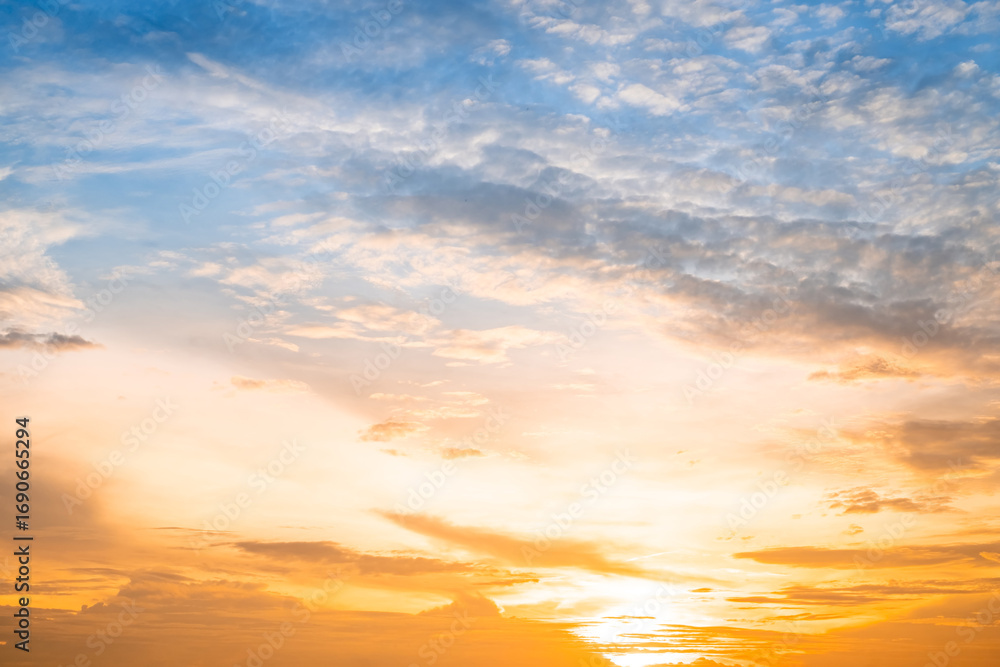 Obraz premium Beautiful , luxury soft gradient orange gold clouds and sunlight on the blue sky perfect for the background, take in evening,Twilight, Large size, high definition landscape photo