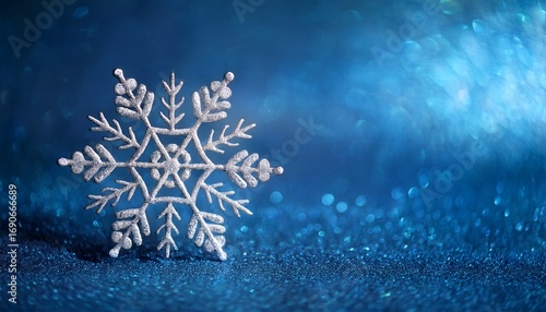 silver snowflake on blue background winter holiday design