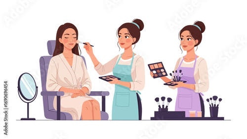 Three diverse women in a beauty salon with one client receiving makeup application and two makeup artists preparing tools and palettes for a professional session