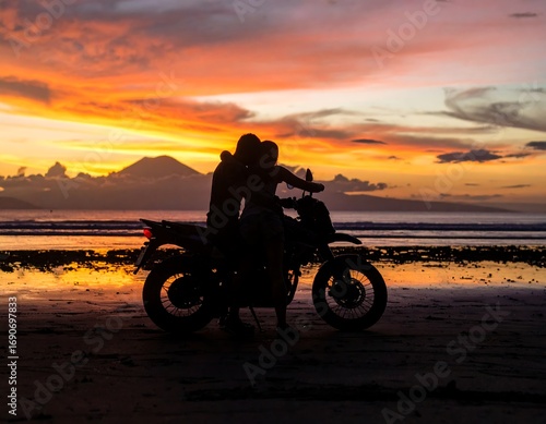 Silhouette couple on motorcycle at sunset beach