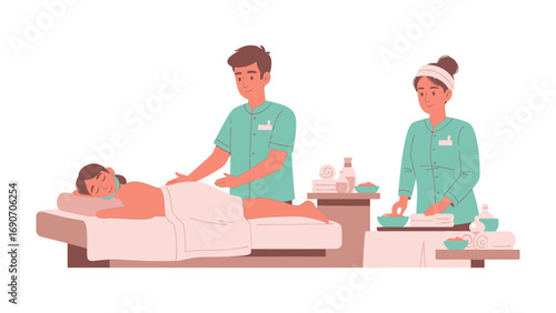 Two professional spa therapists in uniform attending to a client receiving a relaxing massage treatment on a massage table in a tranquil wellness center