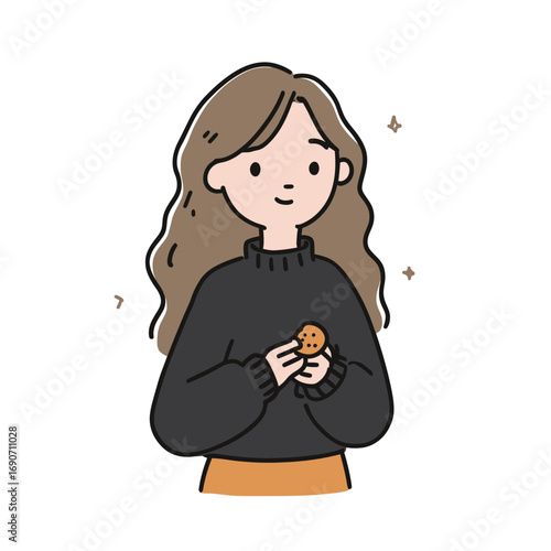 A young woman with long, wavy hair stands joyfully holding a cookie. She wears a dark sweater and has a warm smile in a pleasant atmosphere. The moment captures simple happiness.