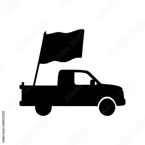 Silhouette of a pickup truck carrying a large waving flag in bed