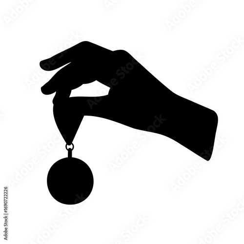 A black silhouette of a hand holding a round ornament is seen