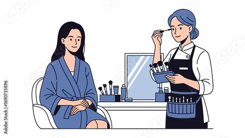 Professional makeup artist applying mascara to a client sitting in a chair wearing a robe in a beauty salon