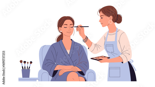 Professional makeup artist applying eyeshadow to a seated woman in a salon with makeup brushes and palette visible