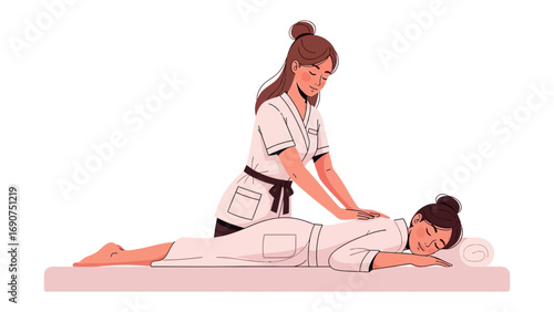Relaxing spa treatment with a professional therapist giving a soothing back massage to a contented client lying on a massage table