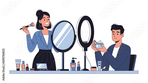 Young woman applying makeup with a brush and a man holding a cosmetic bottle in front of mirrors and ring lights