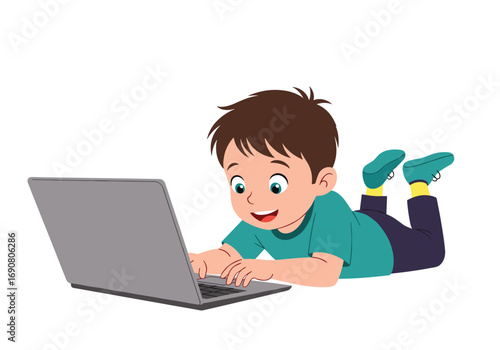 Young boy lying on floor happily typing on laptop computer learning and playing games online
