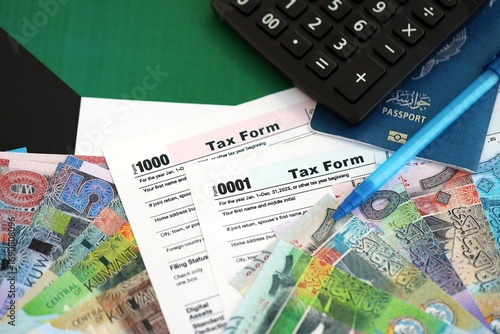 Kuwaiti dinar money bills and calculator with tax form on flag. Taxation and accounting concept