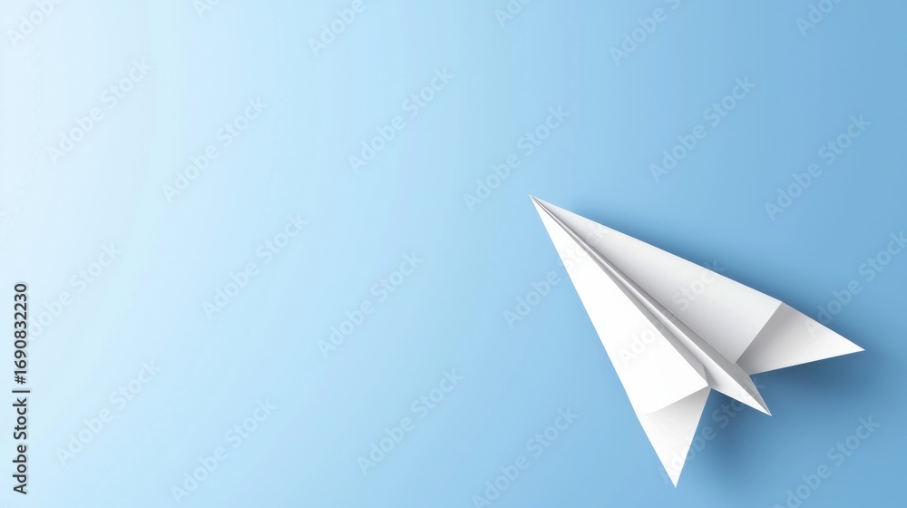 Fototapeta premium A white paper airplane against a light blue background.