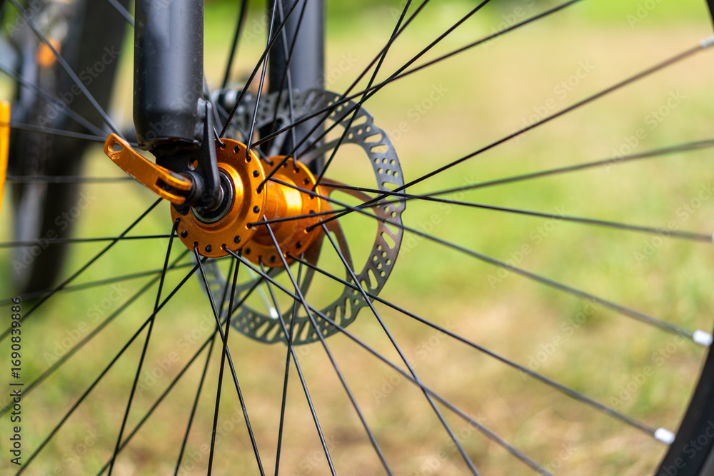 Naklejka premium Orange bicycle hub on the wheel.Mountain bike.