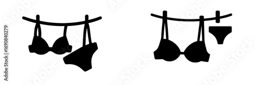 Lingerie icon set with bra and panties hanging on a clothesline for laundry or drying concept in black silhouette style