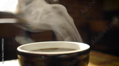 Steaming dark beverage in warm cozy setting