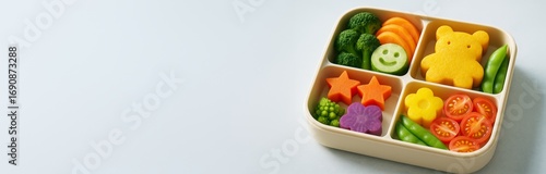 Cute healthy bento box with vegetables shaped like stars, flowers, smiley face and bear on light background with copyspace on left side. Ai generative
