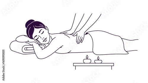 Relaxed woman receiving therapeutic back massage on a towel covered bed in a serene spa environment