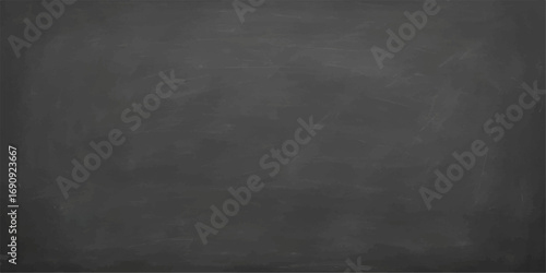 Textured blank chalkboard with vintage blackboard and chalk on a grunge wall