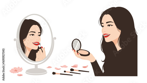 Young woman with long dark hair applying lipstick in a mirror surrounded by makeup and brushes on a white surface