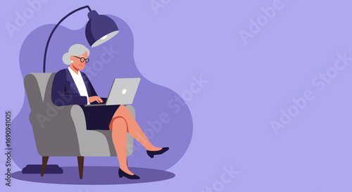 Professional senior woman confidently uses a laptop while sitting in a comfy armchair under a lamp. Perfect for business, education, or lifestyle themes depicting active aging and digital engagement.