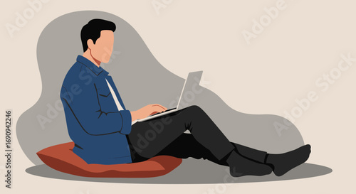 Man working remotely on a laptop, casually sitting on a cushion. Ideal for concepts of home office, freelance work, online education, or modern lifestyle.