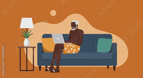 Senior man enjoys remote work from his comfortable home sofa, using a laptop. Illustrates modern lifestyle, digital connectivity, and flexible working.