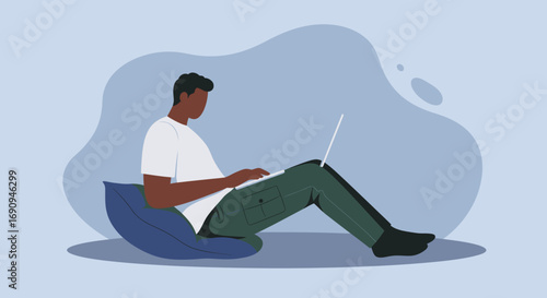 Young man casually working on laptop from home, embodying remote work, digital nomad lifestyle, or online education. Comfortable and focused.