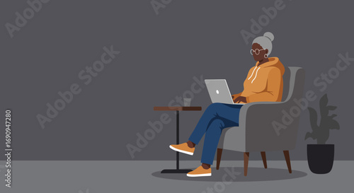 Senior Black woman comfortably working on her laptop from an armchair at home. Represents digital literacy, remote work, or connected lifestyle.