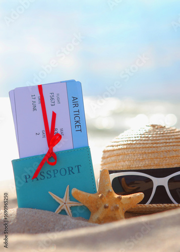 Plane tickets and passport on the beach near the sea close up. Vertical photo format