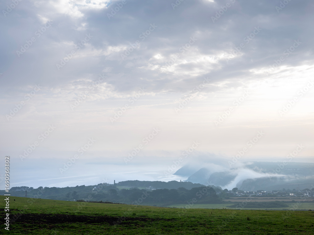 Obraz premium mist creeps up from the sea at st agnes in cornwall on early morning in spring