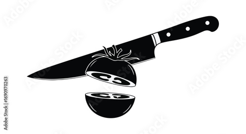 Sharp kitchen knife slicing a fresh tomato in half, preparing for healthy meal.