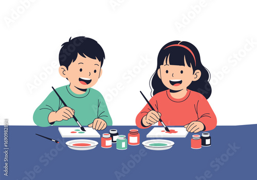 Two smiling young children happily painting pictures together at a table