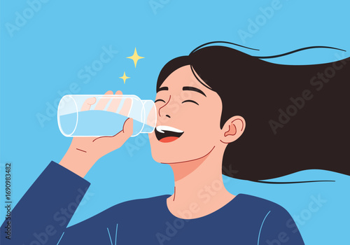 A young woman enjoys drinking fresh cool water from a clear bottle on a bright sunny day