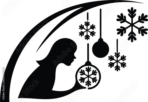 Silhouette of a child gazing at snowflake ornaments hanging from a decorative arch during winter season