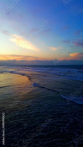 Sunrise Ocean Waves Aerial Drone Footage, Vertical 9:16 Golden Hour Seascape. Peaceful sunrise over the ocean waves, vertical drone seascape golden hour.