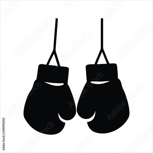 Pair of black boxing gloves hanging on white background