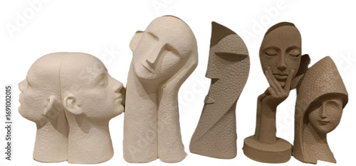 Unique modern sculptures displaying diverse human faces in various shapes and textures arranged artistically