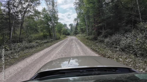 POV Car driving on unpaved rural road in the forest