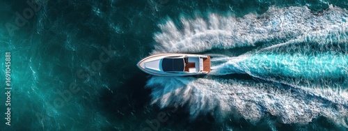High-angle view of a speedboat cutting through turquoise water (5)
