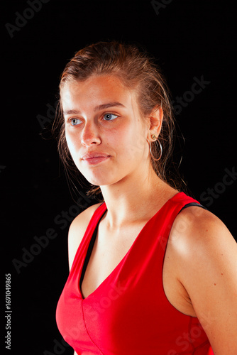 Young and beautiful woman at studio with black backgound
