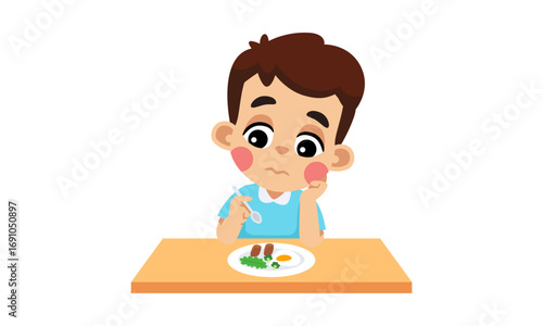 A young boy with a bored expression sits at a table with a plate of food in front of him.
