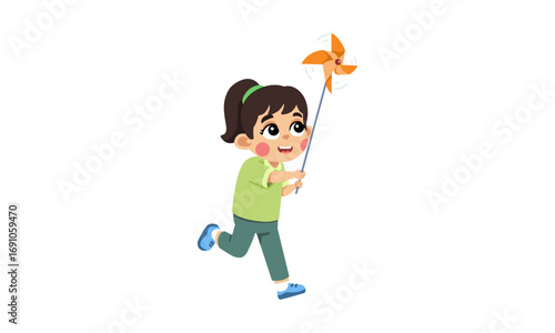 A young girl with dark hair tied in a ponytail, wearing a green shirt and grey pants, joyfully runs while holding an orange pinwheel.