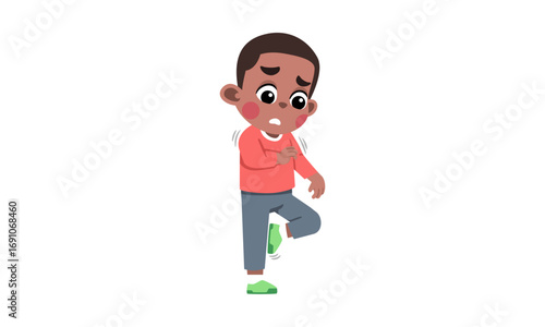 A young boy is looking distressed, possibly because of a problem with his shoe.
