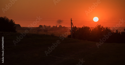 beautiful landscape with silhouettes of trees, buildings against the backgrou...