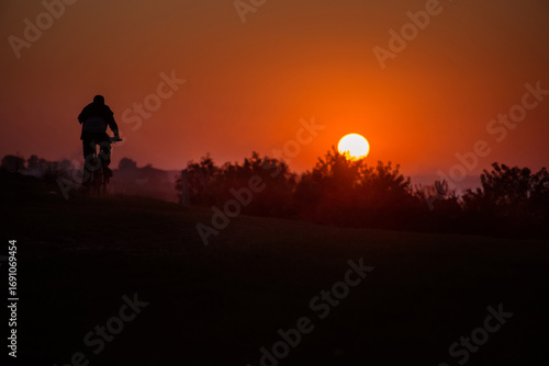 cyclist silhouette ride against the red sky of sunset time